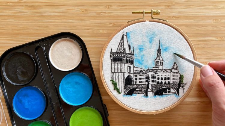 Charles-Henry and Elin Petronella, Elin Petronella - Prague rooftop, 2021. 23cm diameter (9"). Paint, backstitch. Cotton canvas, watercolour paints, DMC mouliné.