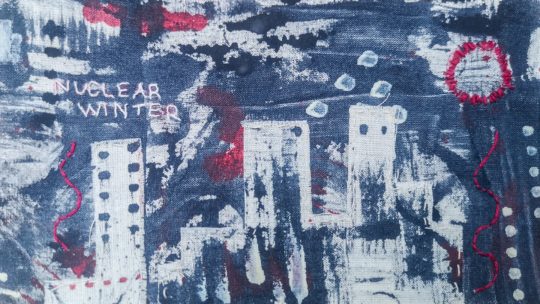 Moyra Costello, Nuclear Winter, 2022. 8cm x 18cm (3” x 7”). Acrylic paint, perle and stranded embroidery thread, linen thread, calico, vintage quilt pieces. Hand stitching, painting on fabric and mark making.
