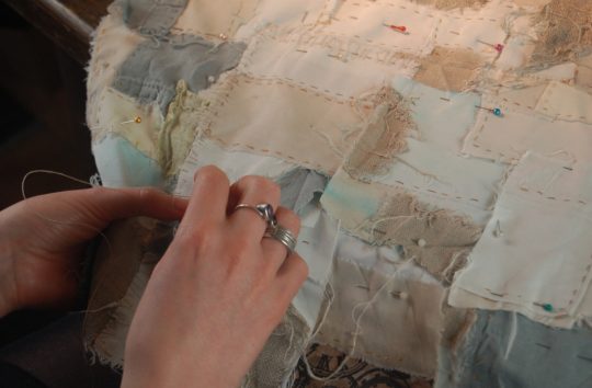 Ruth Norbury at work on the background to one of her works – stitched work that may even not be visible in the final piece.