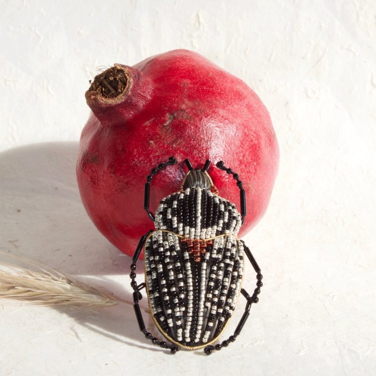Claire de Waard, Goliath Beetle, 2022. 6cm x 3.5cm (2½" x 1⅜"). Stumpwork, straw embroidery, beading. Wool padding, dyed straw, seed beads.