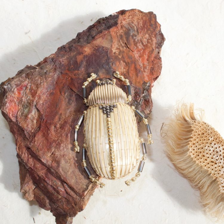 Claire de Waard, Straw Embroidered Beetle Brooch with Schnürli, 2021. 5cm x 3cm (2" x 1¼"). Straw embroidery, goldwork, stumpwork, beading. Straw, straw thread, padding, seed beads, goldwork threads.