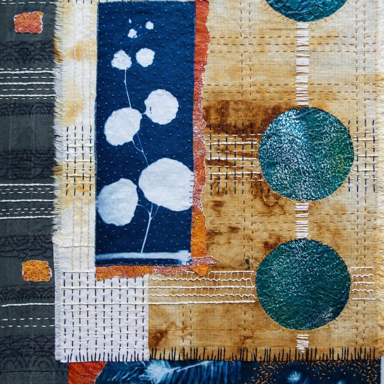 April Sproule, Home, A Sense of Place (detail), 2022. 30cm x 60cm (12” x 24”). Rust dyeing, indigo shibori, cyanotype printing, painted papers, hand appliqué and embroidery. Linen, cotton, silk, paper, cotton embroidery floss.