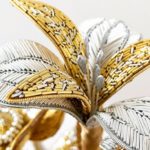 Hannah Mansfield, Summer Goldwork Flower Sculpture (detail), 2019. 40cm x 20cm (15 ¾” x 7 ¾”) including glass dome. Goldwork. Gold and silver goldwork wires, silk organza, metallic thread, metal beads, metallic leaf, silk ribbon, wire, tissue paper and clay.