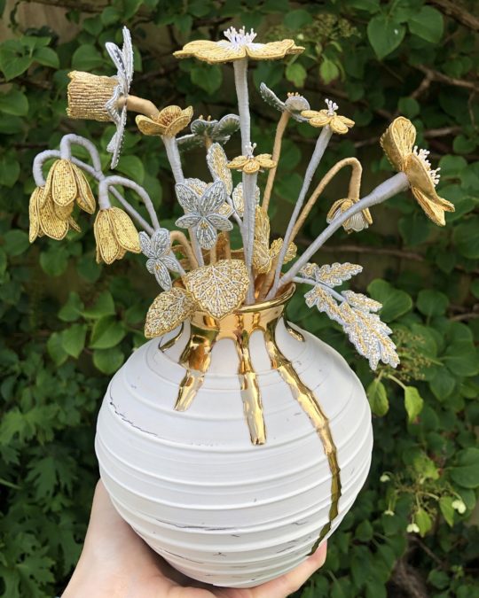 Hannah Mansfield, Goldwork Wildflower Sculpture, 2020. 30cm x 20cm (11 ¾” x 7 ¾”). Goldwork. Gold and silver goldwork wires, silk organza, metal beads, metallic leaf, metallic paint, silk ribbon, wire, tissue paper. Vase by Alex McCarthy.