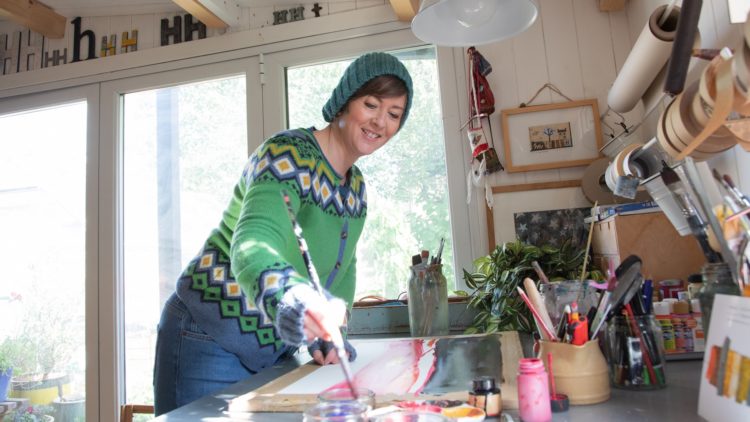 Helen Hallows in her garden studio, always in a woolly hat.