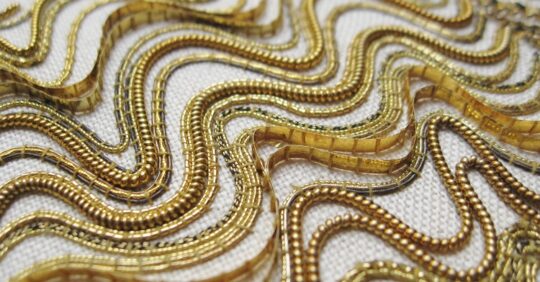 Tracy A Franklin, Linear Goldwork Sampler (detail), 2014. Approximately 15cm x 23cm (6’ x 9”). Goldwork couching. A variety of gold and metal threads worked on linen.