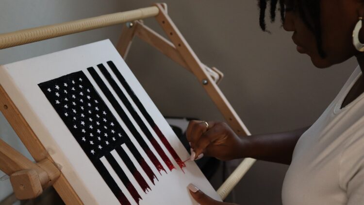 Nneka Jones working on the hand embroidered American Flag for the cover of Time Magazine.