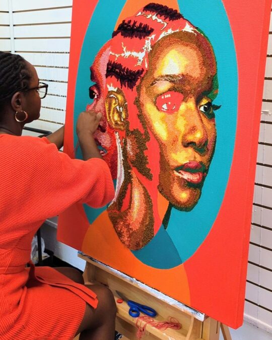 Nneka Jones working on a 76cm x 102cm (30" x 40") textile artwork in her art studio.