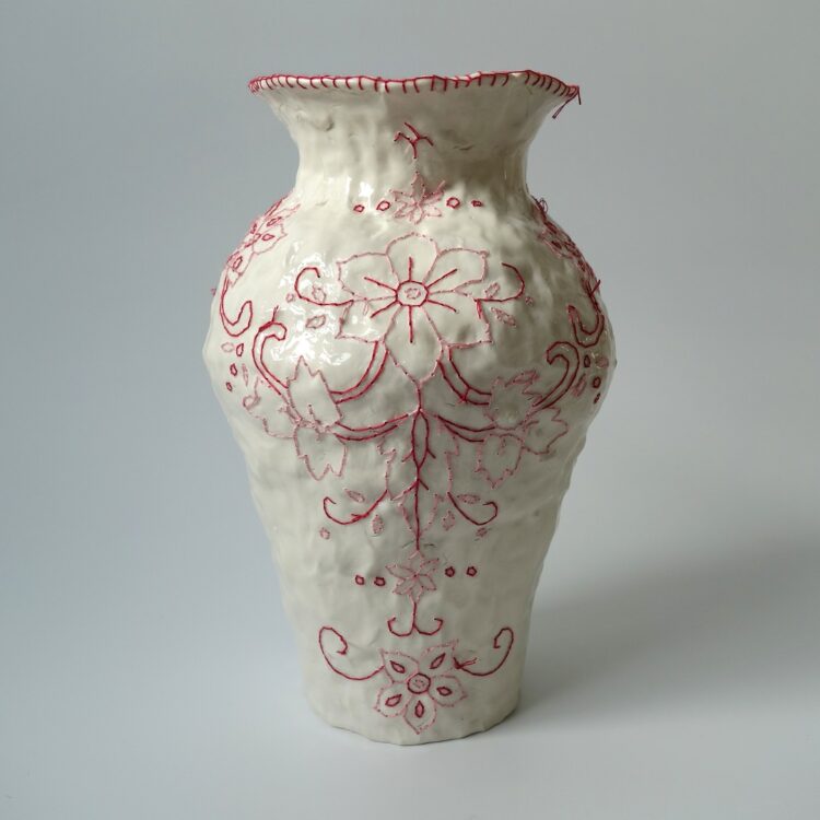 Caroline Harrius, Red Vase, 2023. 25cm tall (10“). Coiled stoneware, embroidered with cotton thread. Stoneware, cotton thread.