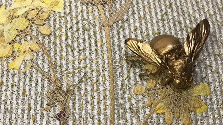 Katherine Diuguid, Rapeseed with Bee (detail), 2019. Approximate size 13cm x 18cm (5” x 7”). Quilting. Gilt preserved bee, pressed rapeseed, silk fabrics, silk threads.