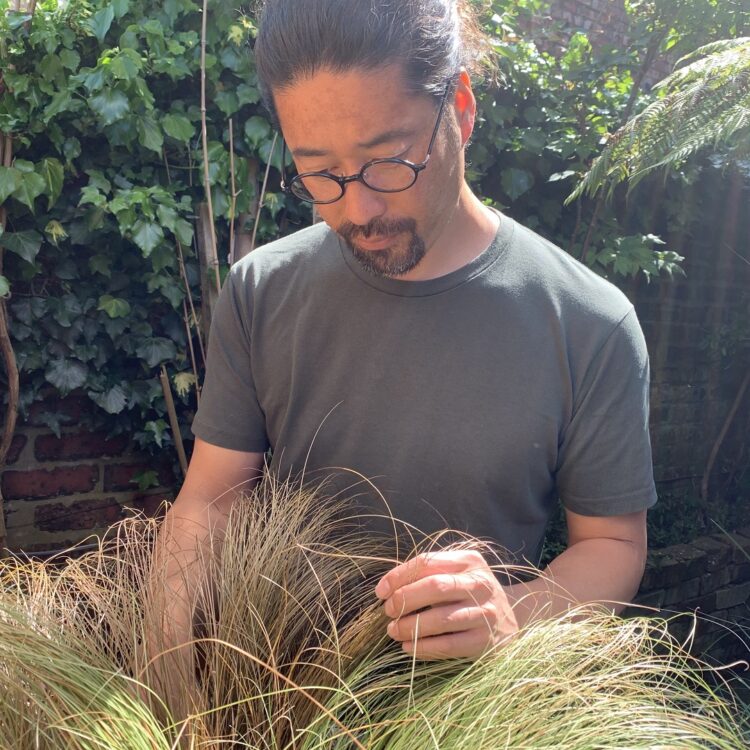 Kazuhito Takadoi tending the grasses in his garden. Photo: Kazuhito Takadoi/jaggedart.