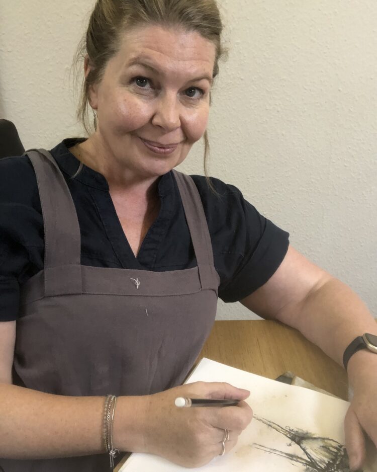 Deb Cooper, sketching in her studio.