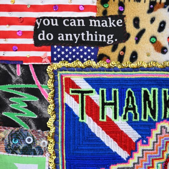 Paul Yore, Thanks for Nothing (detail), 2023. 90cm x 87cm (35" x 34"). Needlepoint, appliqué, assemblage. Wool, needlepoint, appliquéd found textile materials, sequins, buttons, beads. Frame is comprised of wood, acrylic, found objects, toys, mirror and LED. Photo: Devon Ackermann.