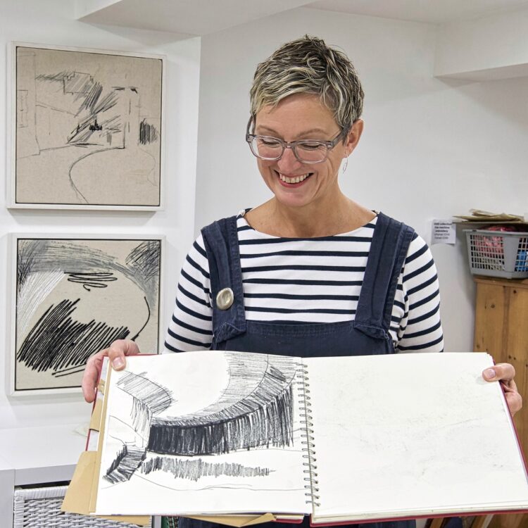 Dionne Swift in the studio with her drawings