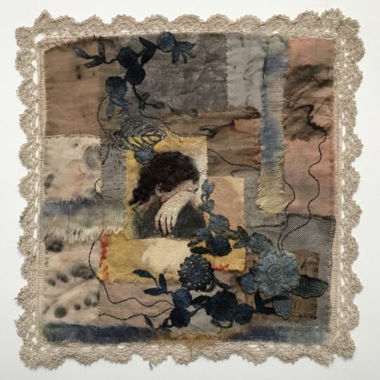 Lesley Wood, Done & Dusted (Domestic Series), 2021. 35cm x 35 cm (13½" x 13½"). Hand embroidered fabric collage. Vintage table napkin, pieces of hand dyed (with tea, rust and ink) fabrics including domestic yellow duster, lace, metal leaves, paint, wool, embroidery threads.