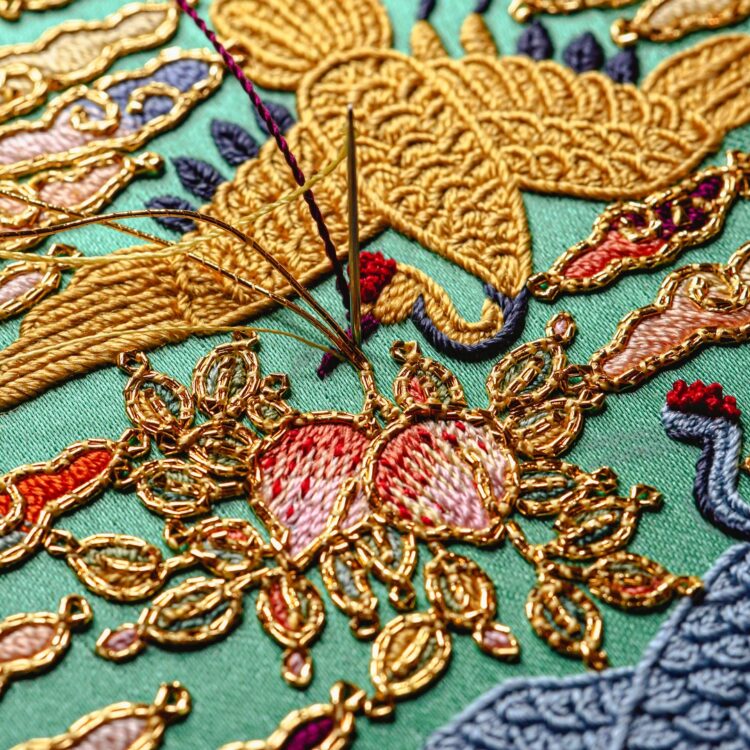 Heewha Jo, Baegaet-mo, Pillow end with two cranes holding peaches (detail), 2023. 13cm (12½") diameter. Hand embroidery. Silk and gold thread, silk satin.