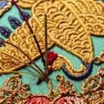 Heewha Jo, Baegaet-mo, Pillow end with two cranes holding peaches (detail), 2023. 13cm (12½") diameter. Hand embroidery. Silk and gold thread, silk satin.