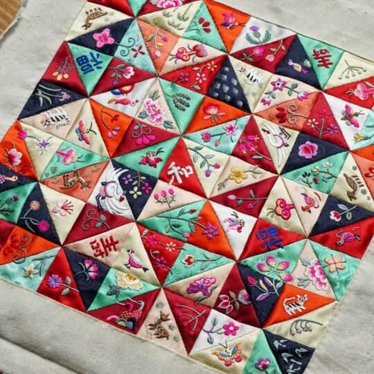 Heewha Jo, Jogak-Bojagi, patchwork wrapping cloth with my memories in Scotland and England (work in progress). 37cm x 37cm (14½" x 14½"). Hand embroidery. Silk thread, silk fabric.