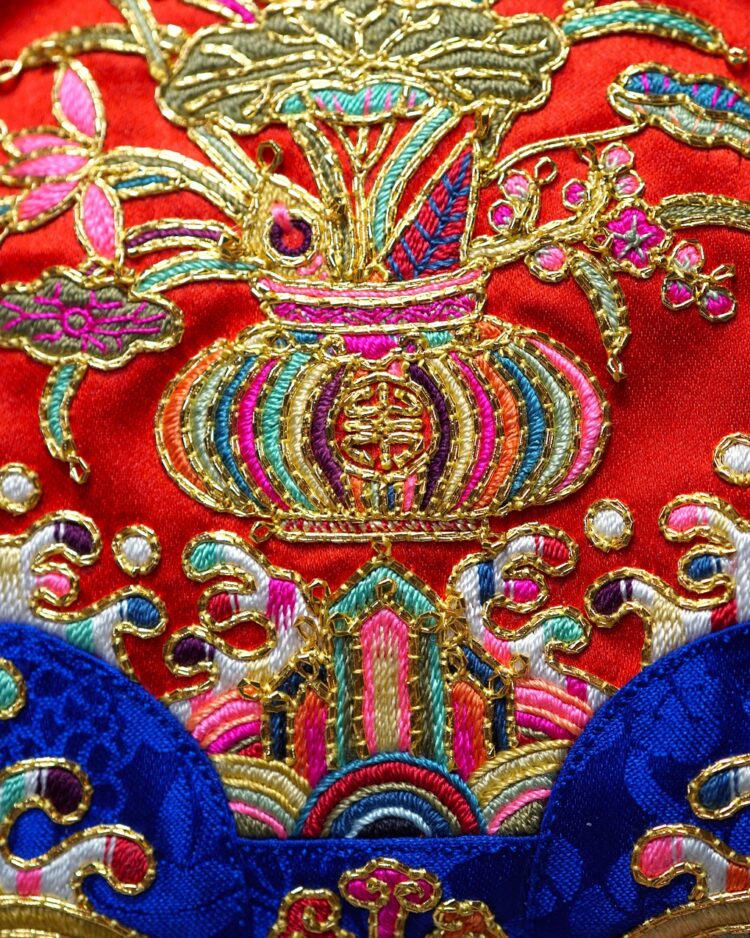 Heewha Jo, Gui-Jumeoni, eared pouch with lotus design (detail), 2021. 14cm x 13.5cm (5½"
x 5"). Hand embroidery. Silk and gold thread, silk satin.