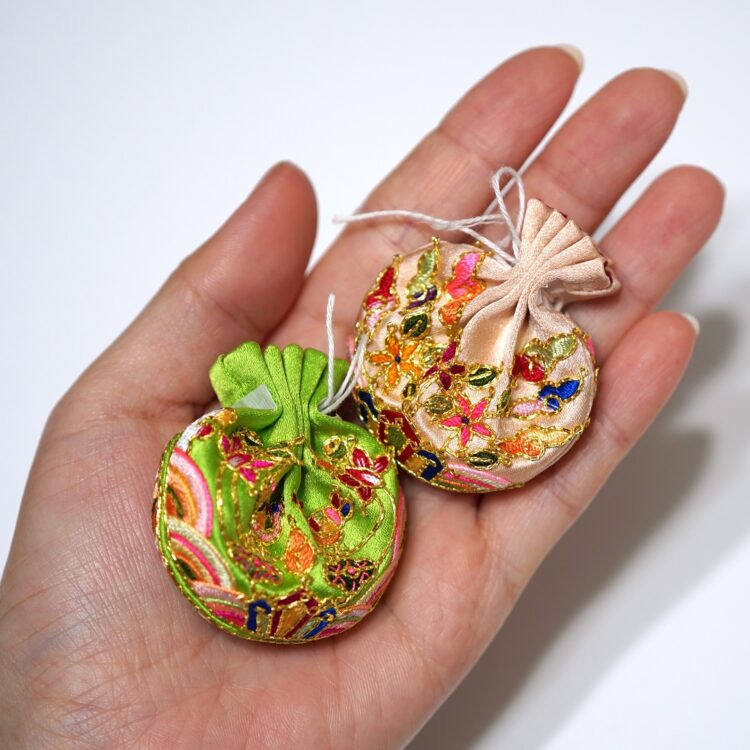 Heewha Jo, Duru-Jumeoni-Norigae, round pouch ornaments (before attaching strings), 2020.
Each 4.5cm x 5cm (1¾" x 2”). Hand embroidery. Silk and gold thread, silk satin.