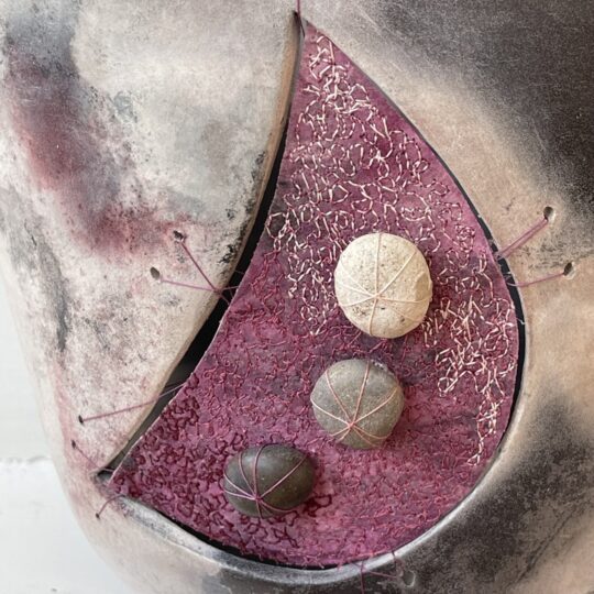 Martine Becquet and Rachael Singleton, Pink Smoke Fired Pot (detail), 2020. 15cm x 30cm (6" x 12"). Smoke fired clay, machine stitching, free machine embroidery. Decovil 1 interfacing, teabag paper, bonded paper, pebbles.