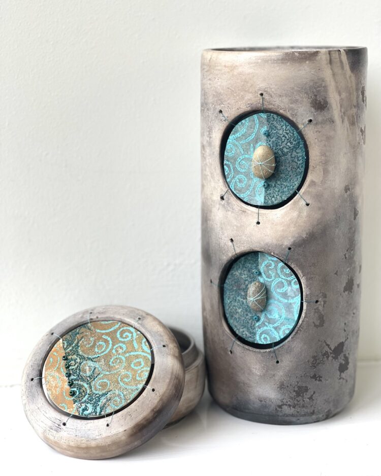 Martine Becquet and Rachael Singleton, Two Vessels, Turquoise Inclusions, 2022. 12cm x 30cm, 15cm x 12cm (5" x 12", 6" x 5"). Smoke fired clay, machine stitching, free machine embroidery. Decovil 1 interfacing, teabag paper, bonded paper, pebbles.
