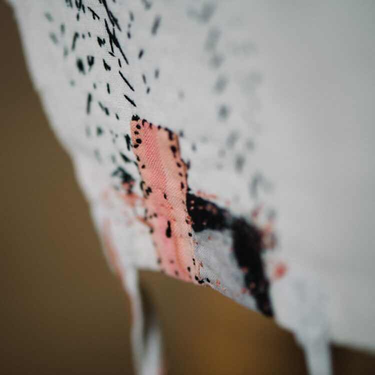 Kate Whitehead, Daughter (detail), 2019. 32cm x 16cm (12½" x 6½"). Child’s vintage cotton bodice, black silk, black and pink fabric patches, pink silk embroidery thread. Embroidery. Photo: Sarah Mason Photography.