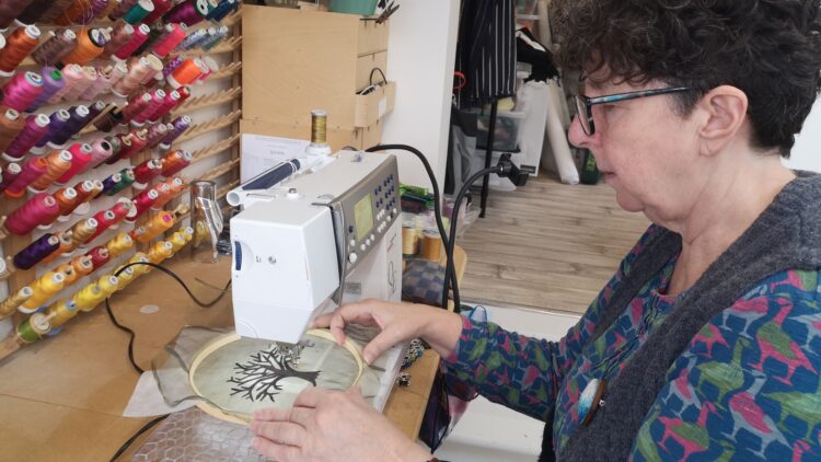Angie Hughes at her sewing machine.