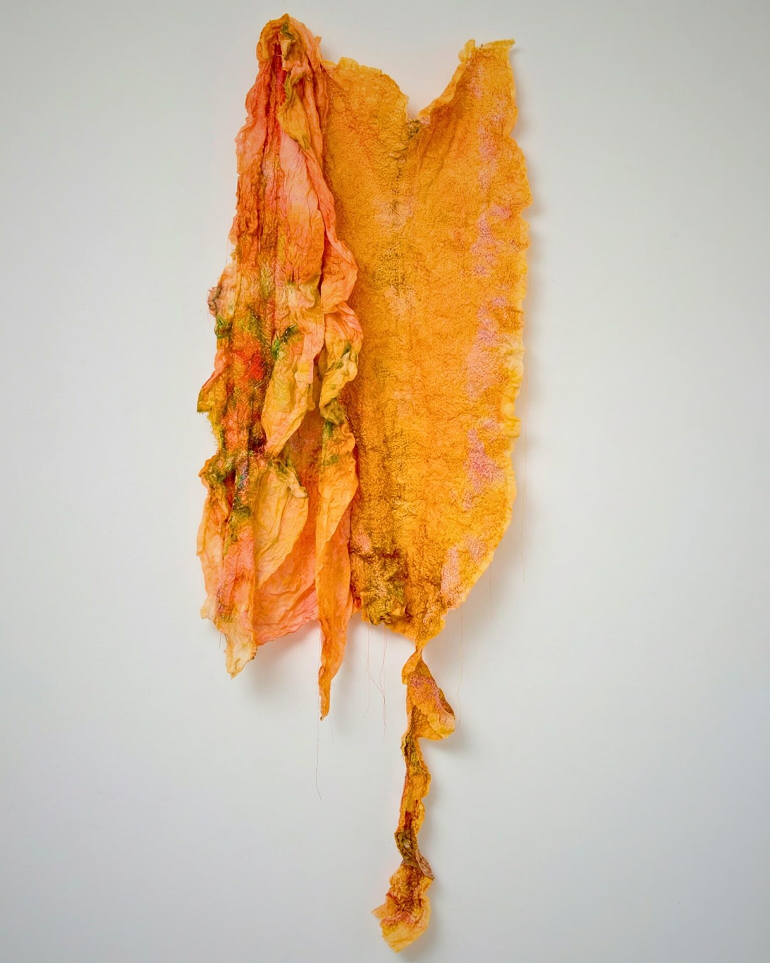 Textured orange and pink fabric artwork