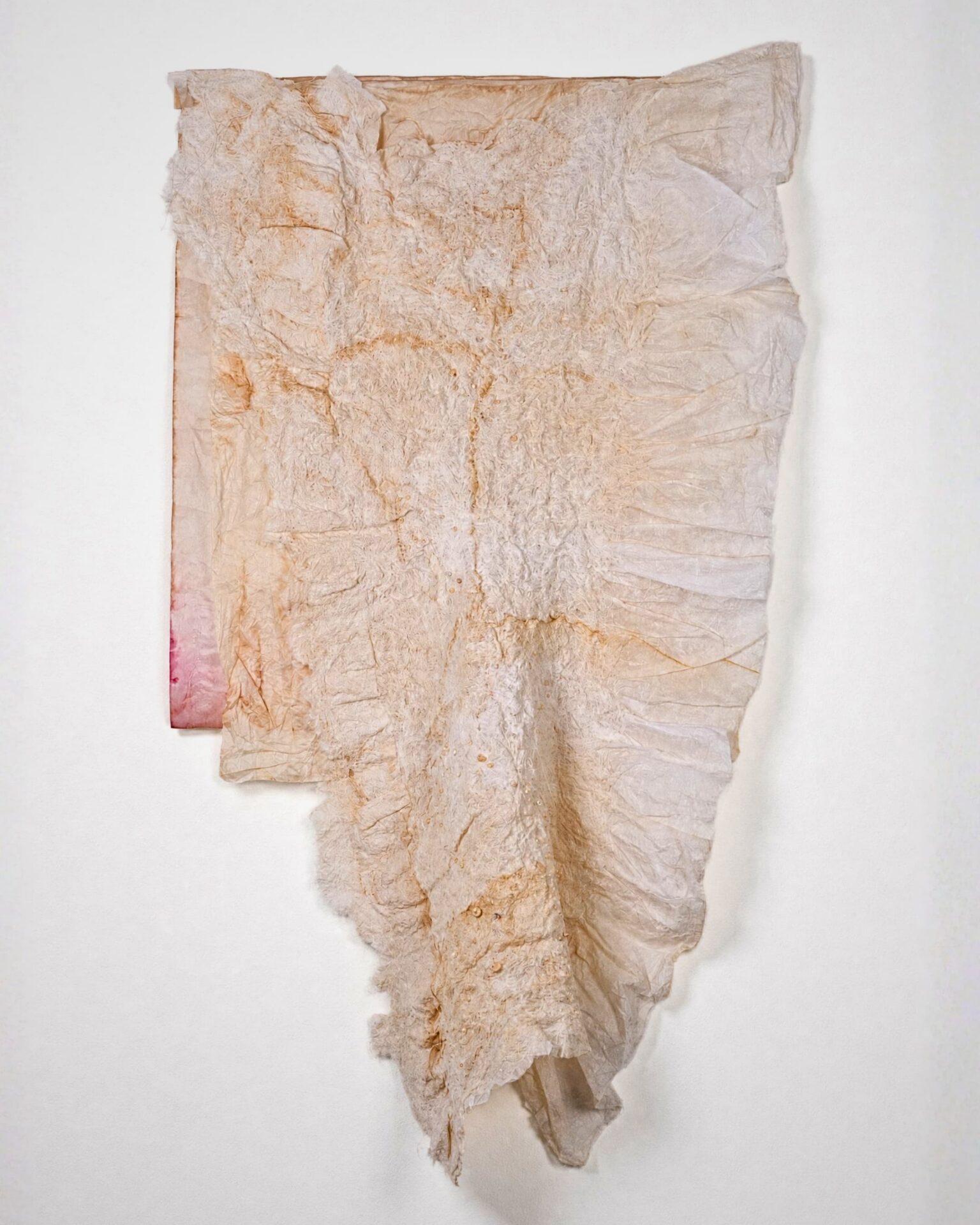 Textured fabric draped on wall.