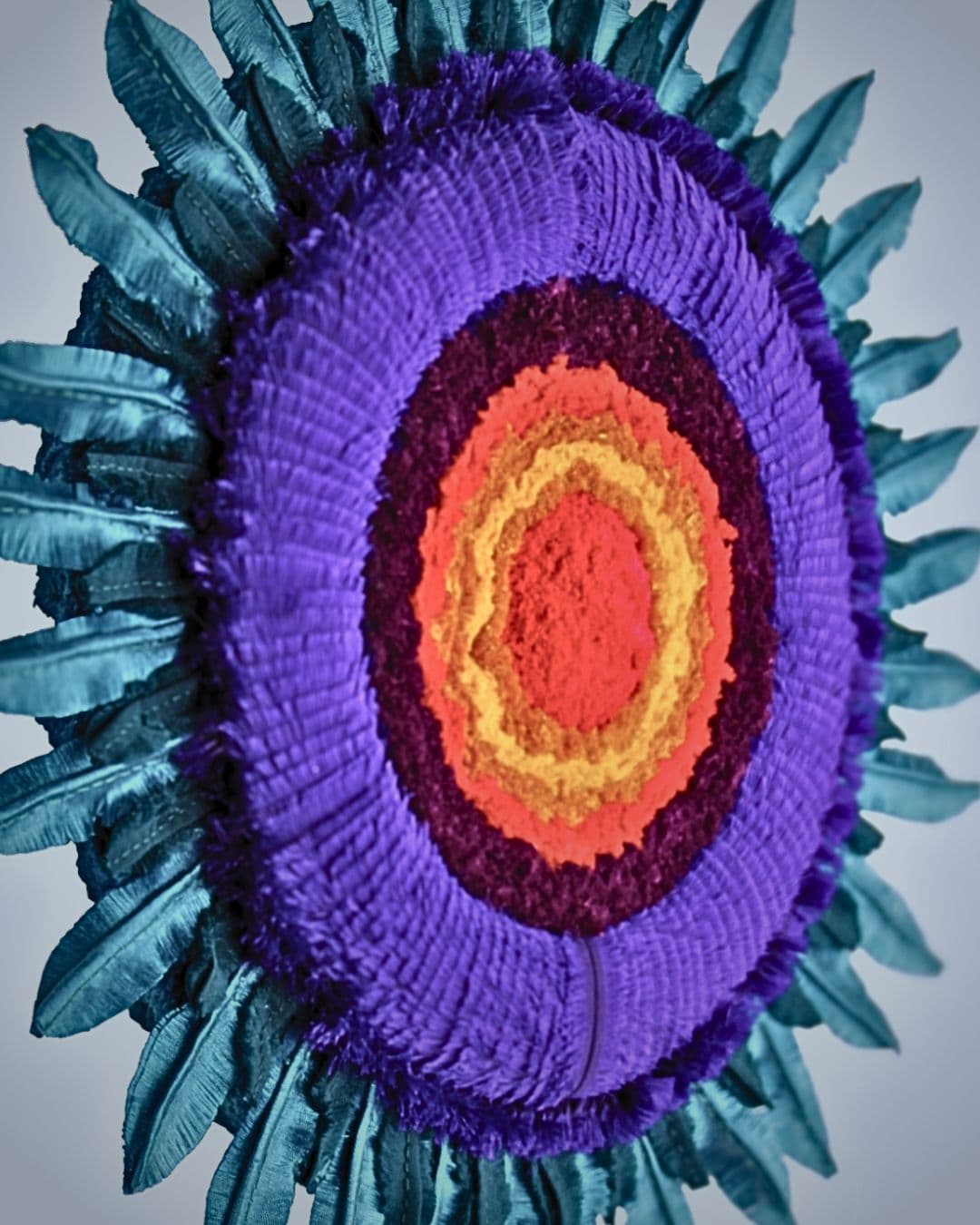 Vibrant coloured circular textile wall art made from various textile materials
