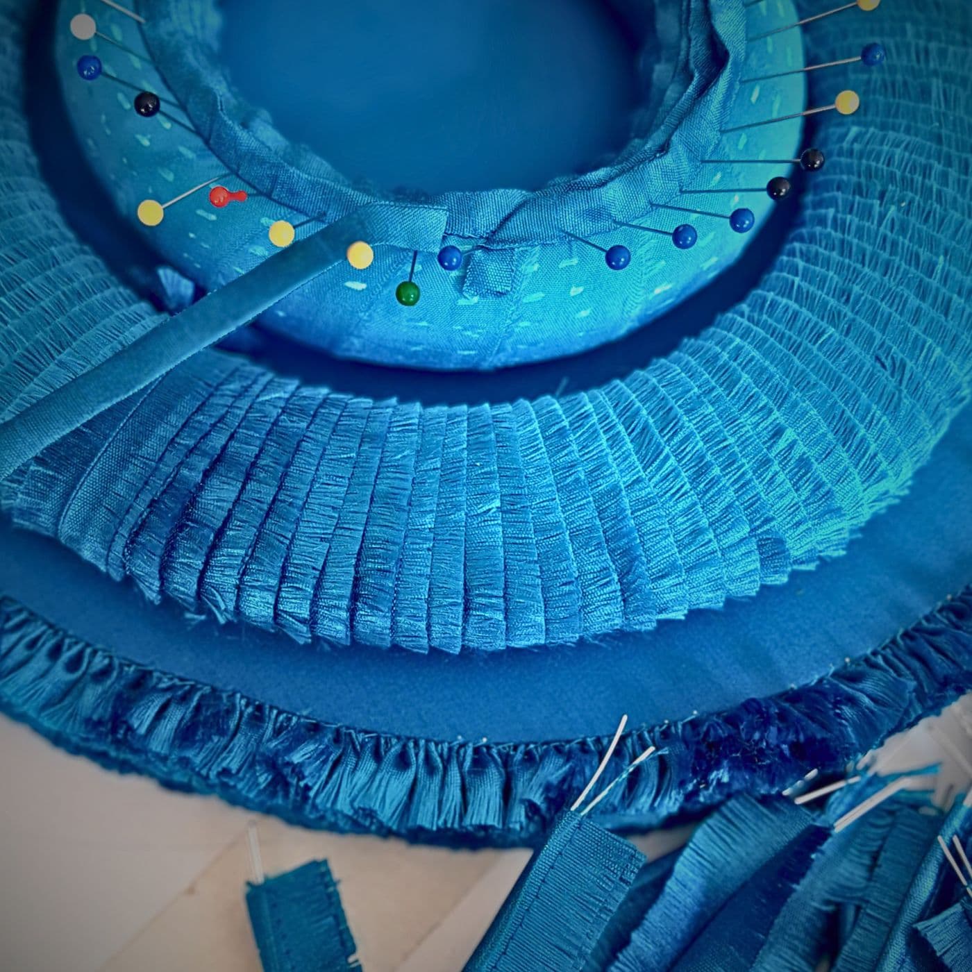 Constructing a layered blue piece of textile wall art.