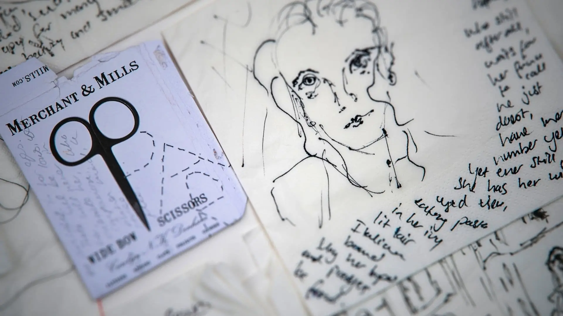 A close up ink drawing of a woman with scissors and a piece of paper
