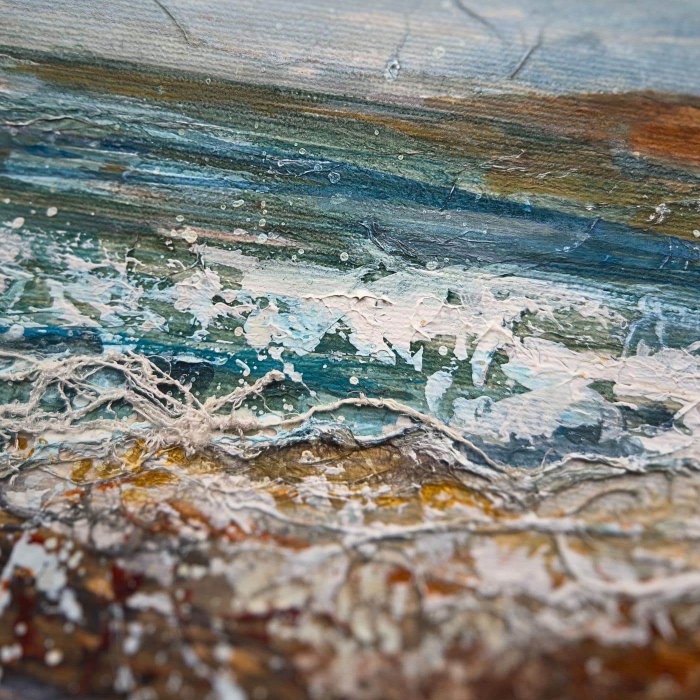 A close up of a painting of the sea with stitching