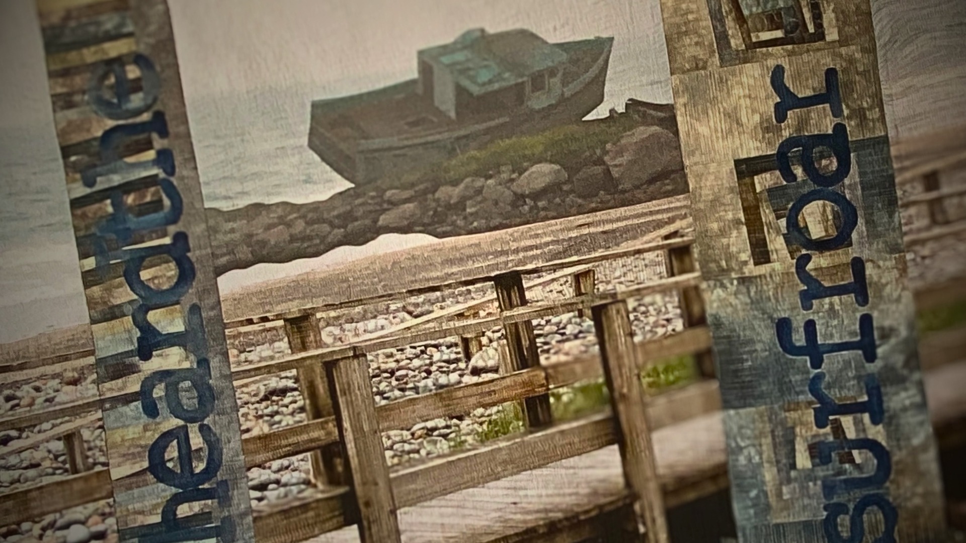 Abandoned boat near rocky shoreline.