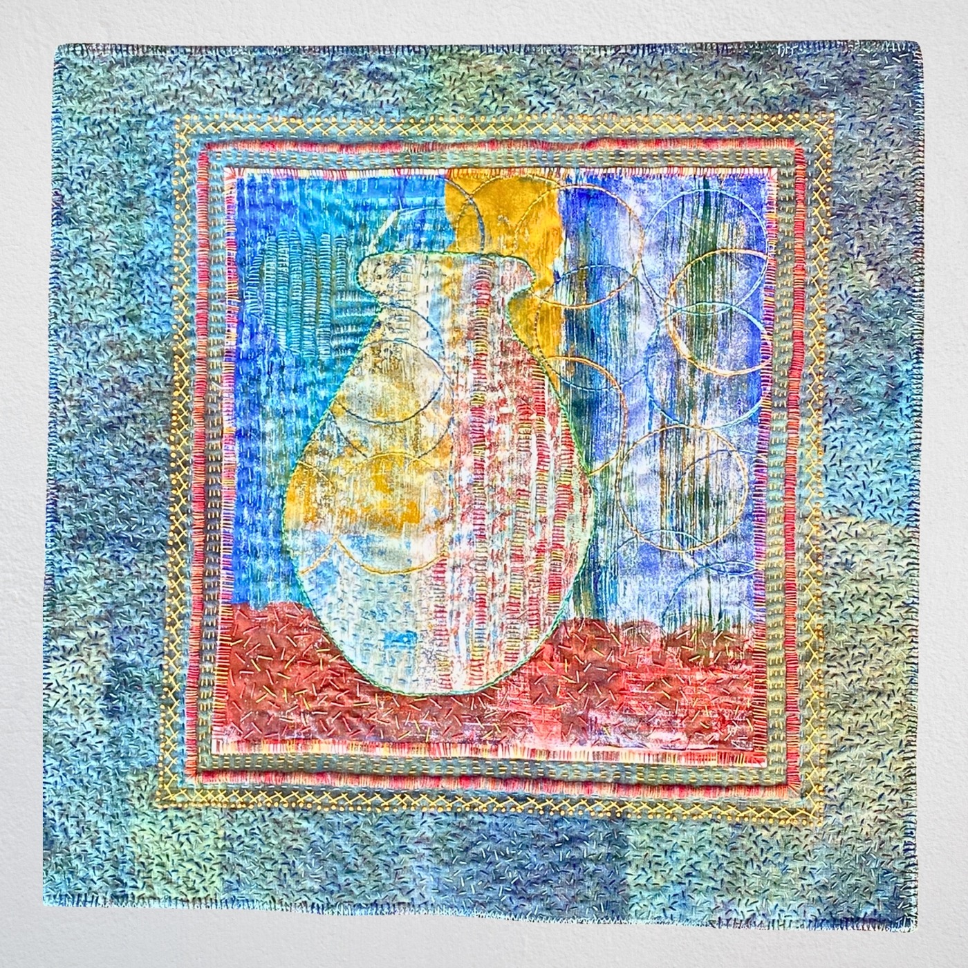 Colourful textile art featuring a vase