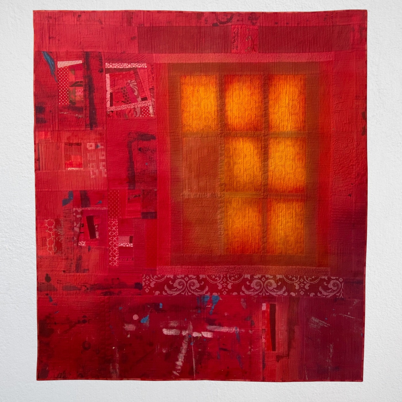 Abstract red textile art with glowing window