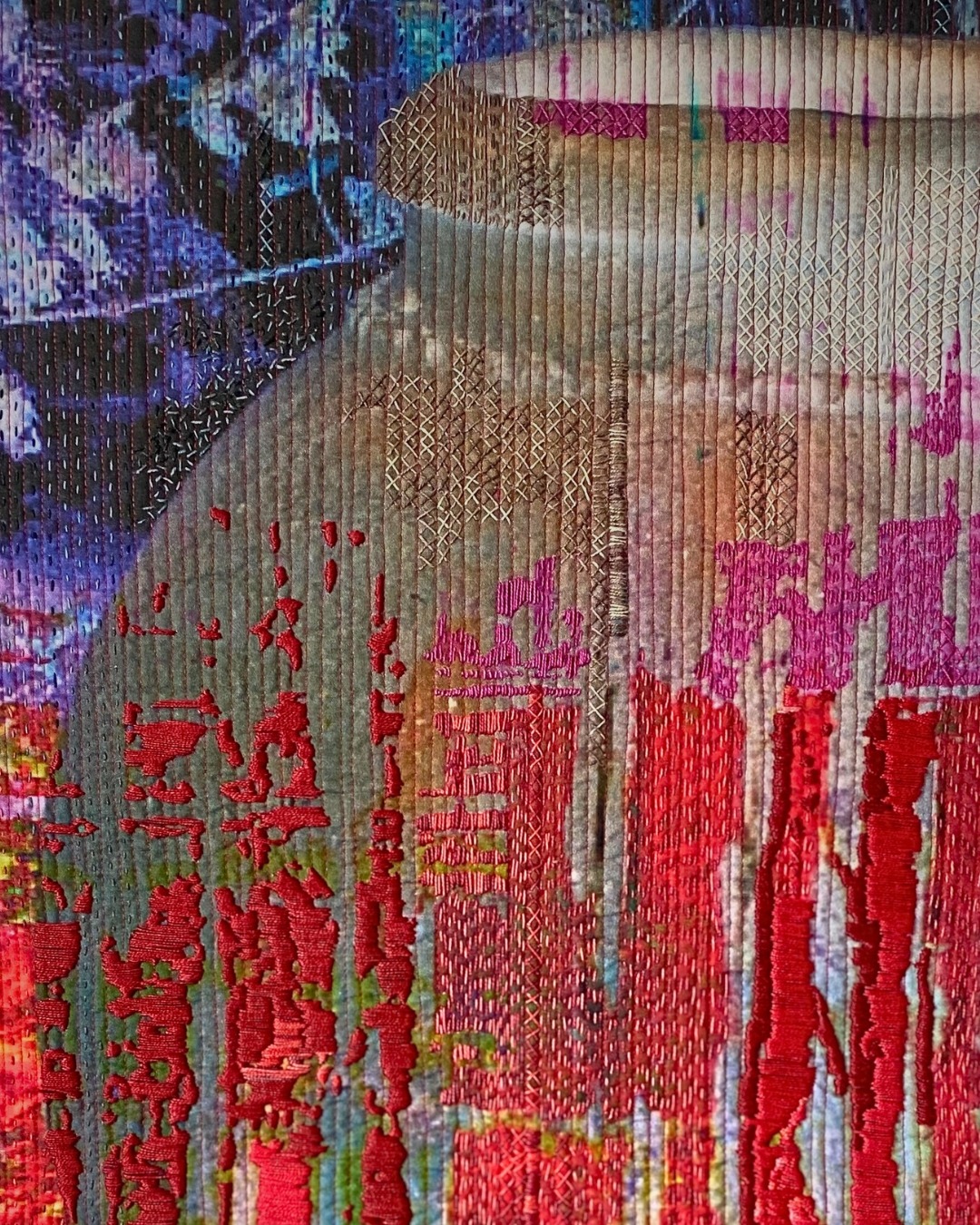Abstract textile art of a pot with vibrant colours.
