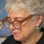 A close up image of textile artist Anne Kelly working in her studio.