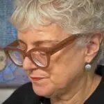 A close up image of textile artist Anne Kelly working in her studio.