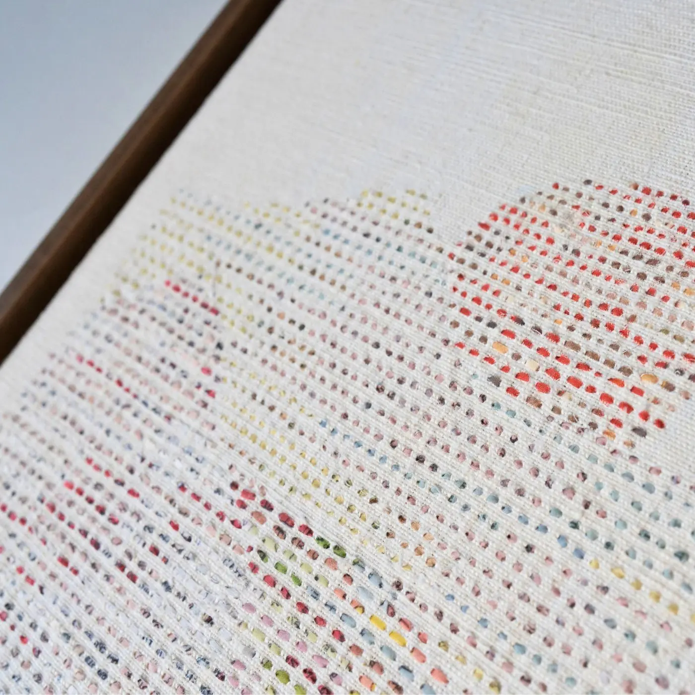A close up of a framed stitched artwork