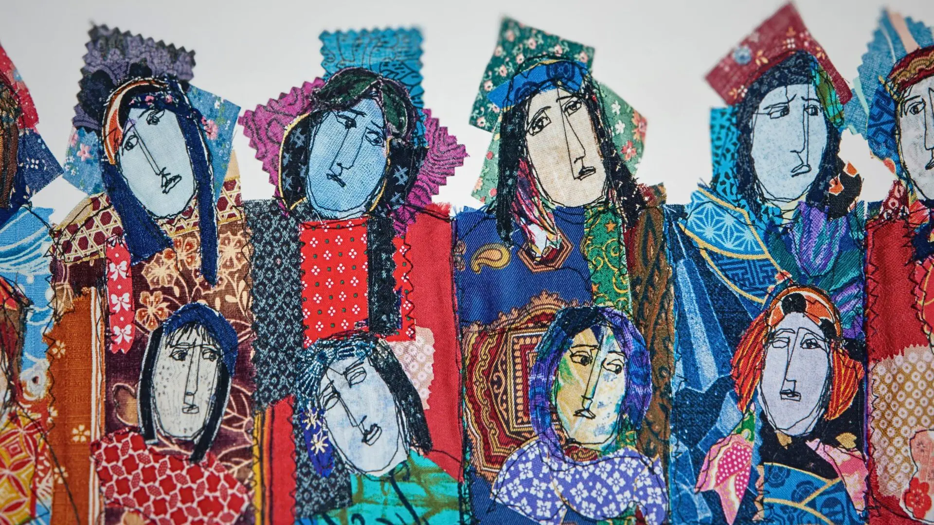 Colourful fabric portraits of diverse women.