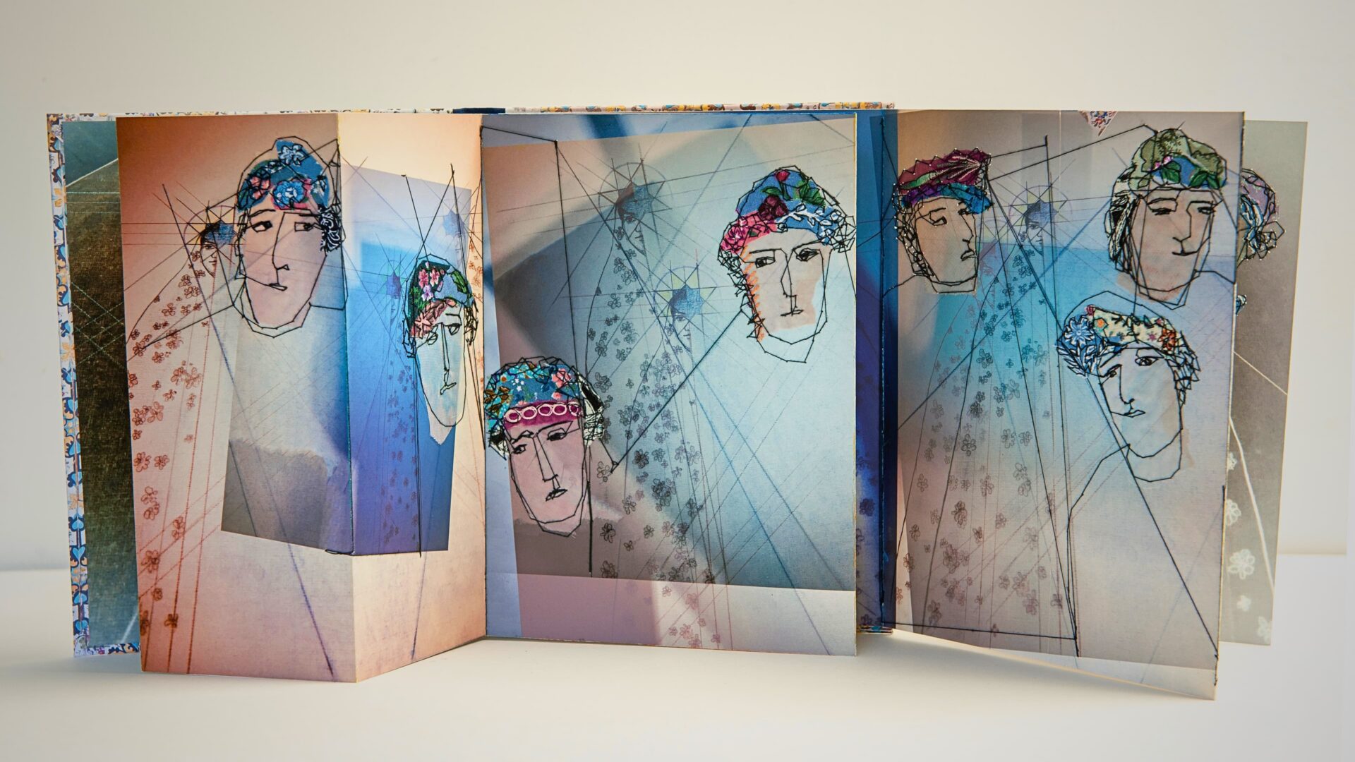 Artistic depiction of stylised figures in concertina book