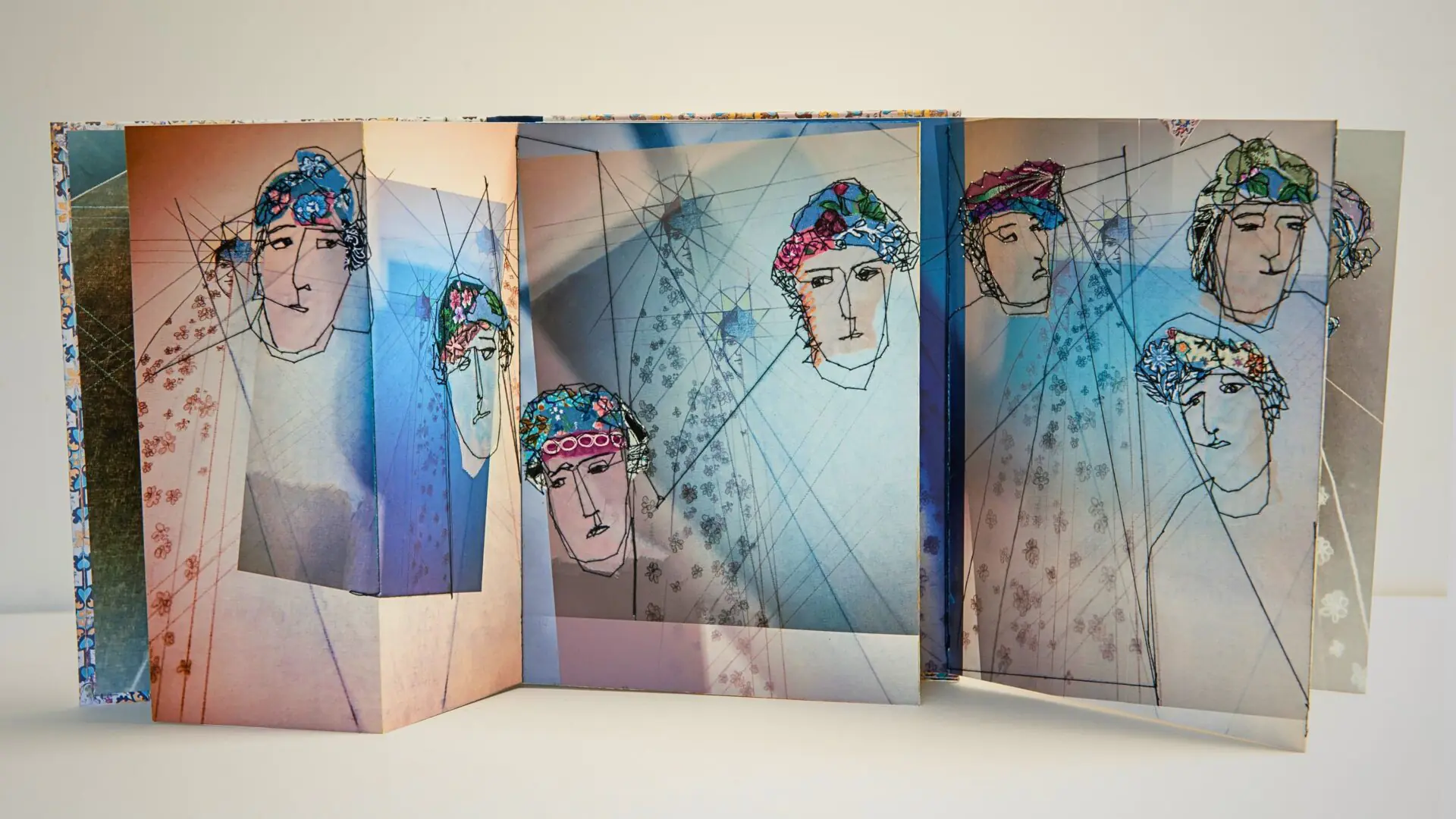 Artistic depiction of stylised figures in concertina book