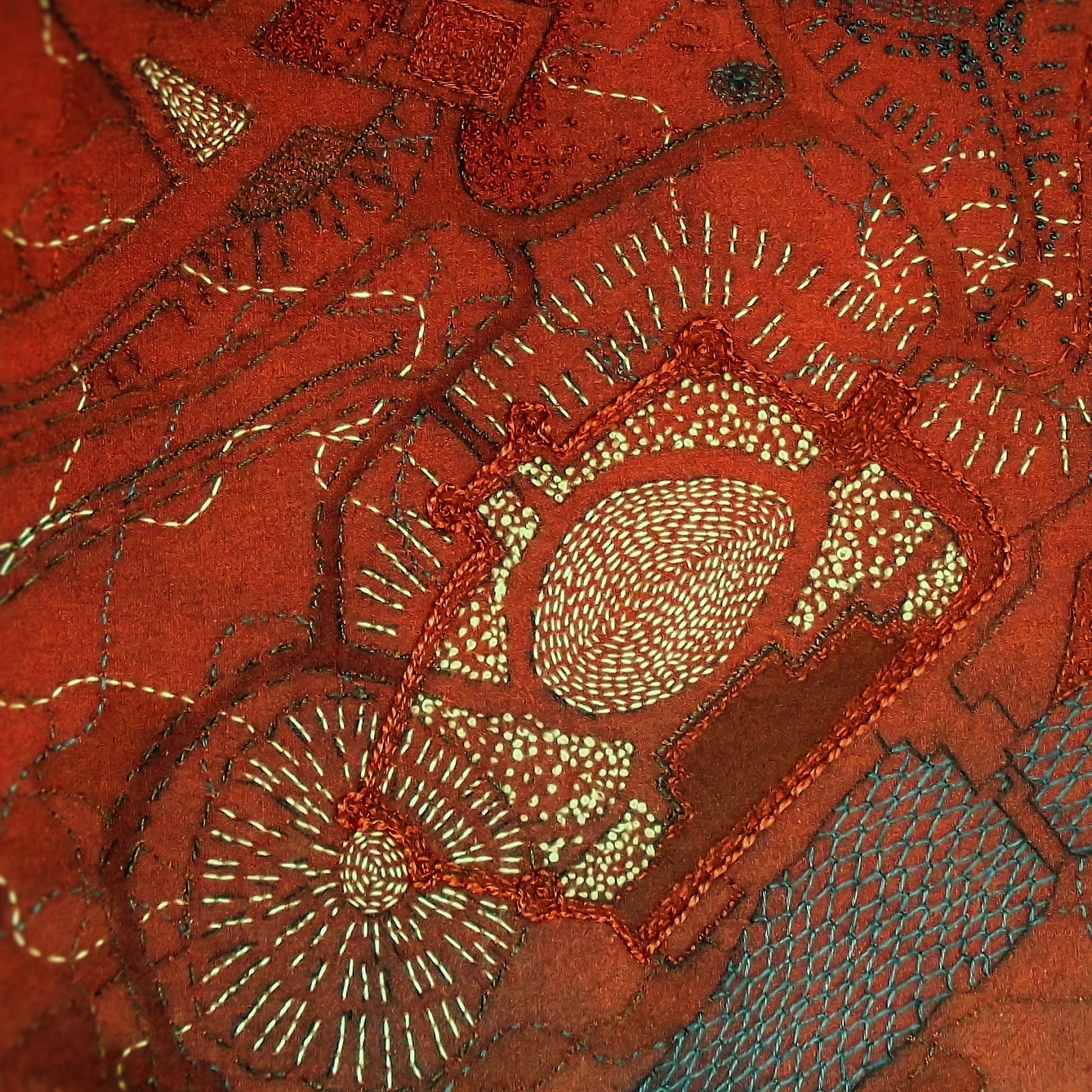 A red piece of fabric with  gold embroidery
