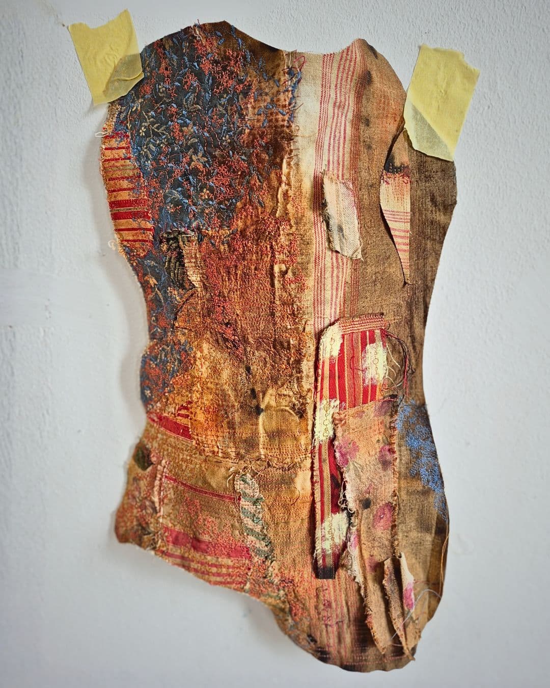 Textured fabric artwork with vibrant colours.