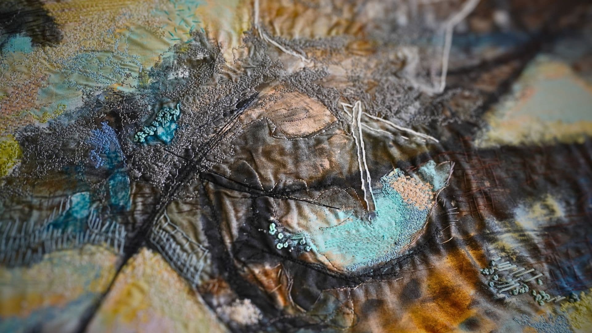 Textured landscape artwork made with various fabrics and materials