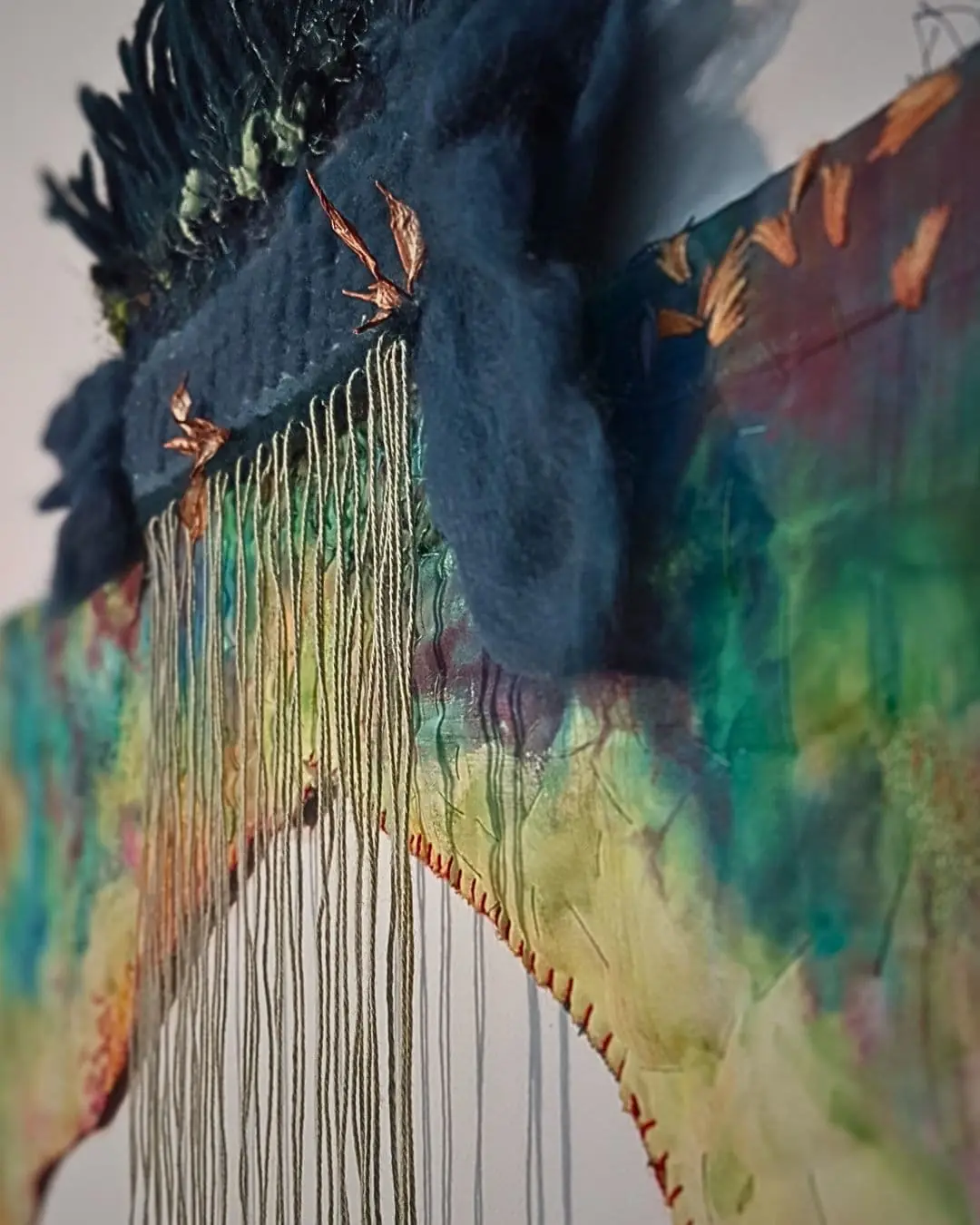 Vibrant textile artwork with intricate details made through weaving, hand and machine embroidery.