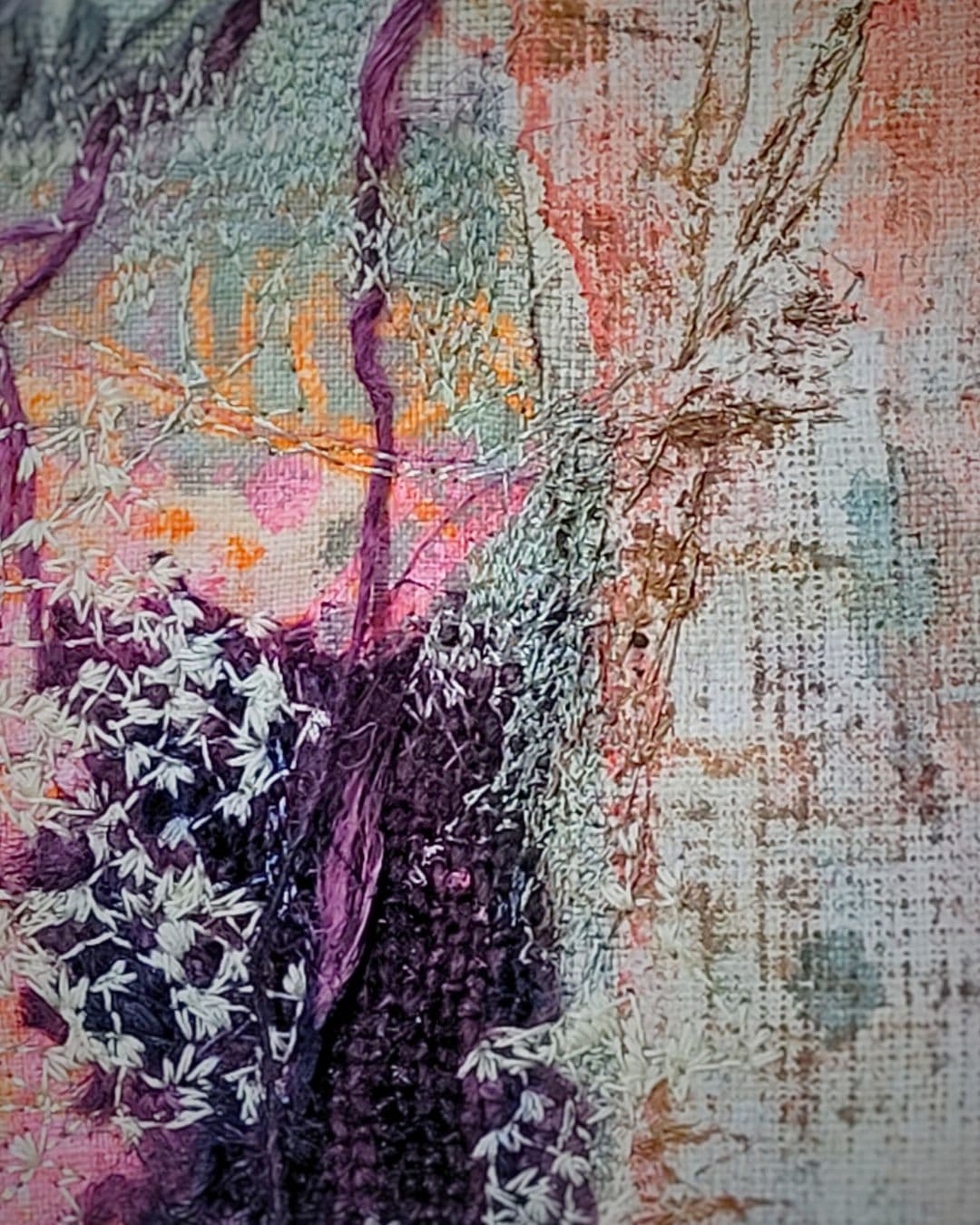 Textured fabric artwork with natural motifs.