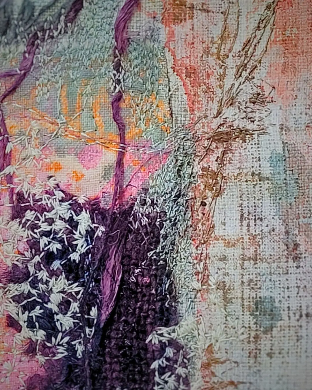 Textured fabric artwork with natural motifs.